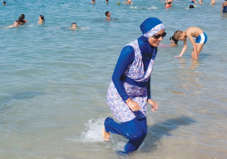 A WOMAN WEARS a burkini at a beach in Marseille yesterday.